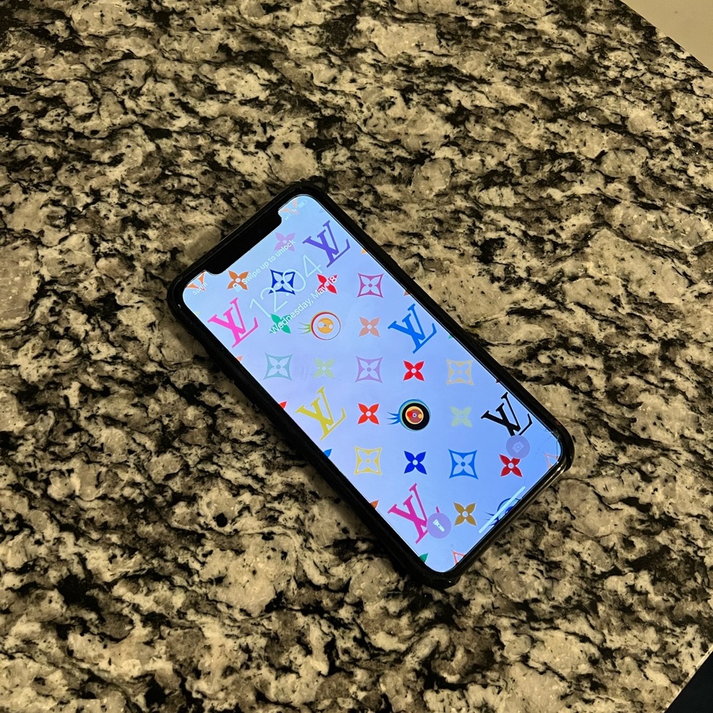 Apple iPhone X (10). Comes with glass screen protector and black leather case.